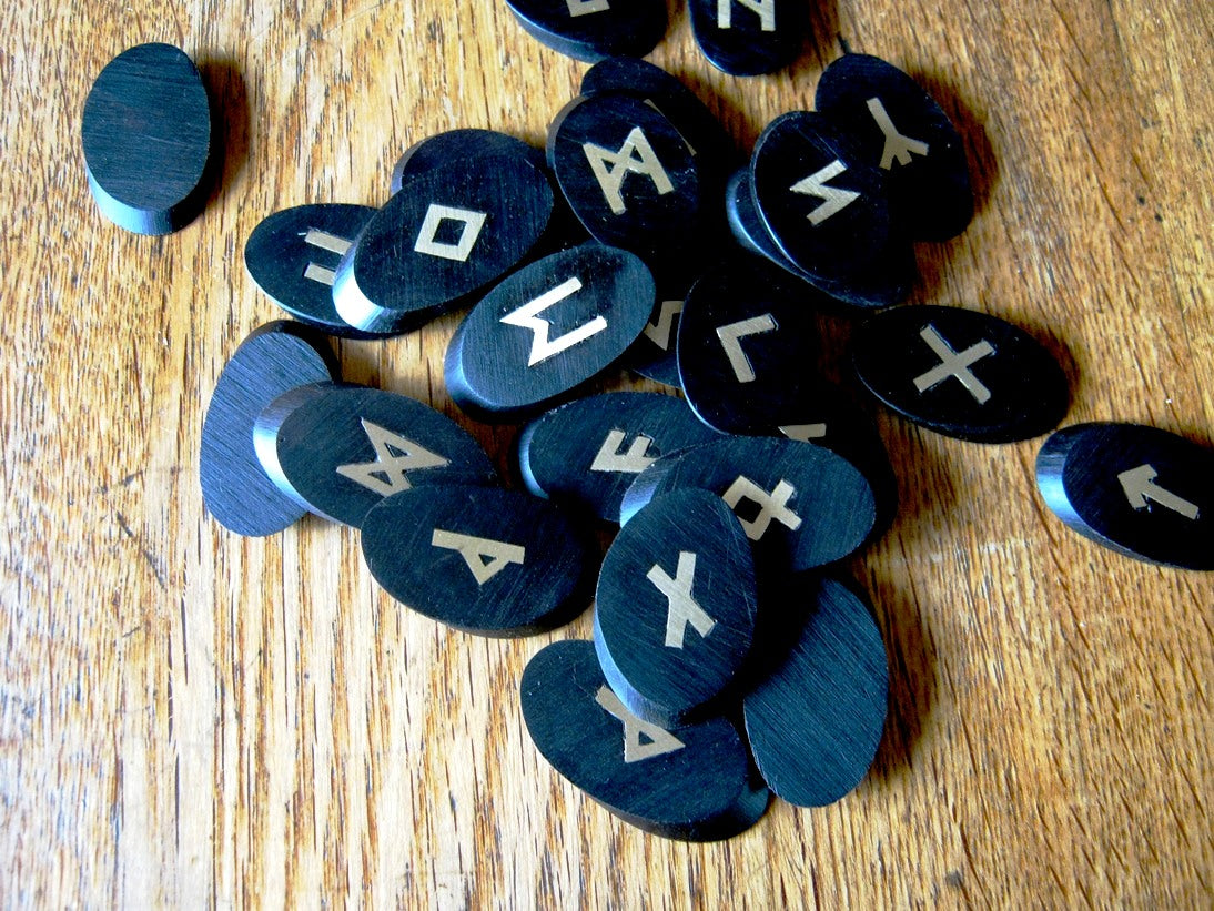 African Ebony Elder Futhark runes in Brass on wood