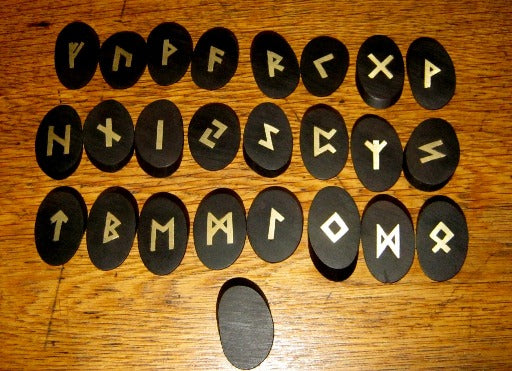 Ebony and brass runes. Elder Futhark runes in African Ebony wood